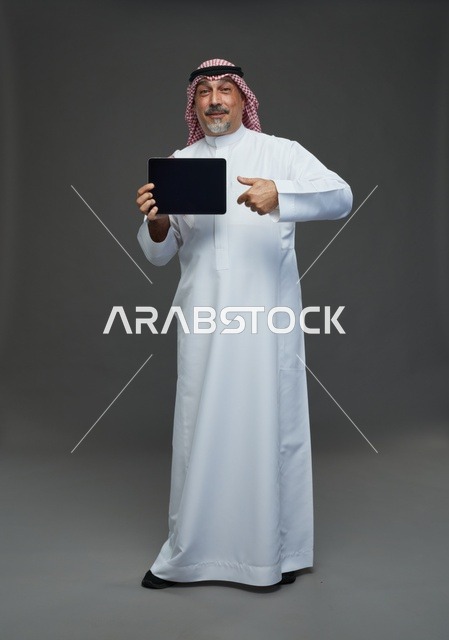 Senior Saudi Man Using Digital Tablet in Studio