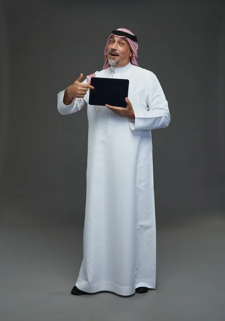 Elderly Saudi Man Pointing at Tablet in Studio