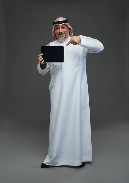 Elderly Saudi Man Pointing at Tablet in Studio