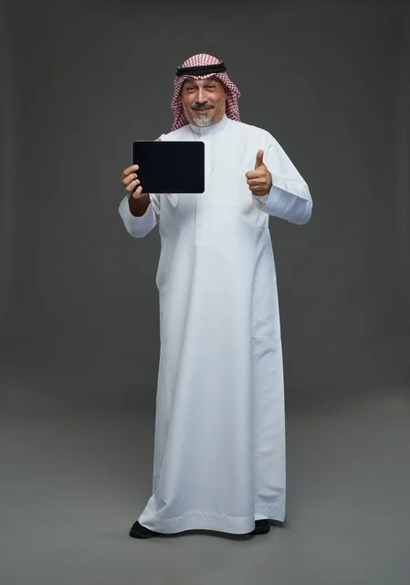 Elderly Saudi Man Holding Tablet with Thumbs Up
