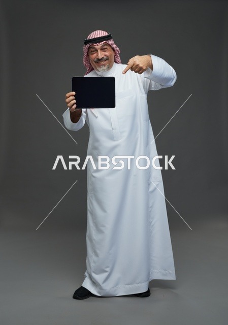 Elderly Saudi Man Pointing at Digital Tablet Studio