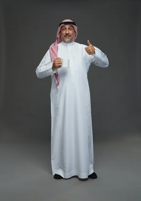 Saudi Elderly Man with Coffee Mug Thumbs Up Portrait