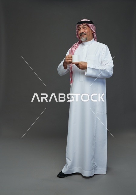 Elderly Saudi Man Holding White Coffee Mug in Studio