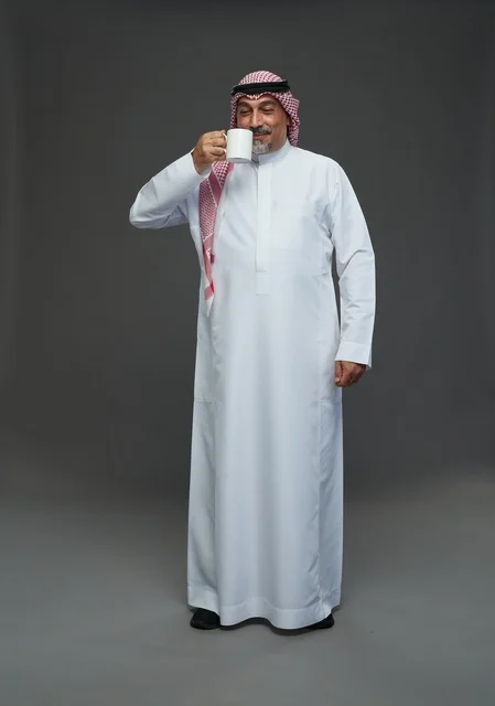 Elderly Saudi Man Holding White Coffee Mug in Studio