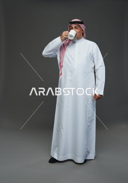 Elderly Saudi Man Drinking Coffee in Traditional Attire