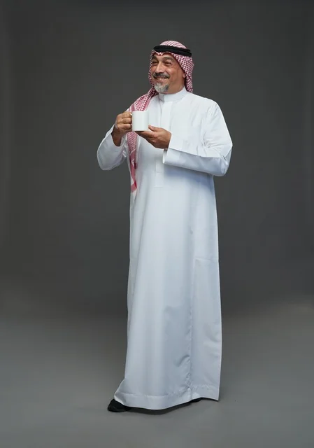 Saudi Man Holding White Coffee Mug in Studio