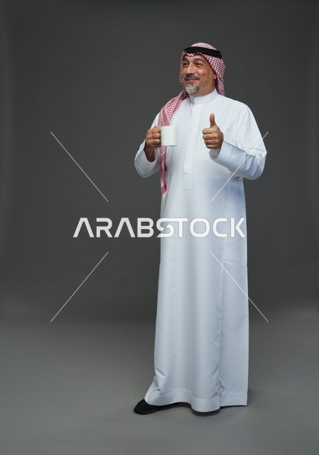 Saudi Elderly Man with Coffee Mug Thumbs Up