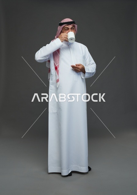 Elderly Saudi Man Drinking from White Mug in Studio