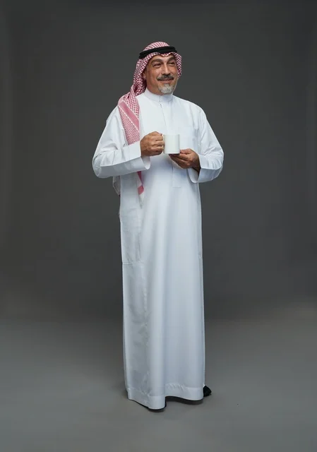 Elderly Saudi Man Holding White Coffee Mug in Studio