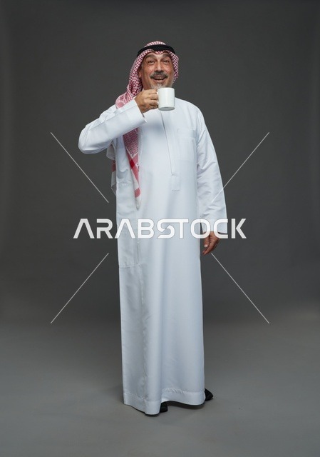Elderly Saudi Man in Traditional Thobe with White Coffee Mug