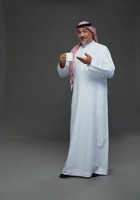 Senior Saudi Man Holding Coffee Mug Studio Portrait