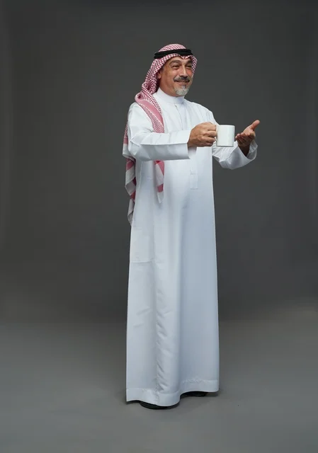 Elderly Saudi Man Holding White Coffee Mug in Studio