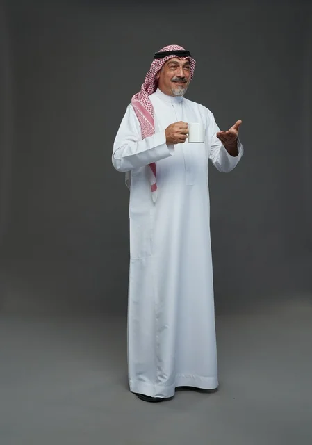 Elderly Saudi Man Holding White Coffee Mug in Studio