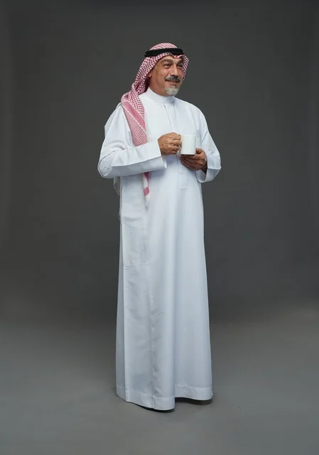 Elderly Saudi Man Holding White Coffee Mug in Studio