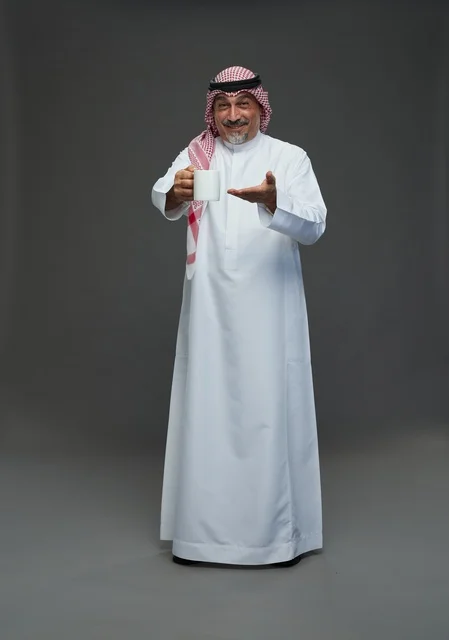 Saudi Elderly Man Holding White Coffee Mug in Studio