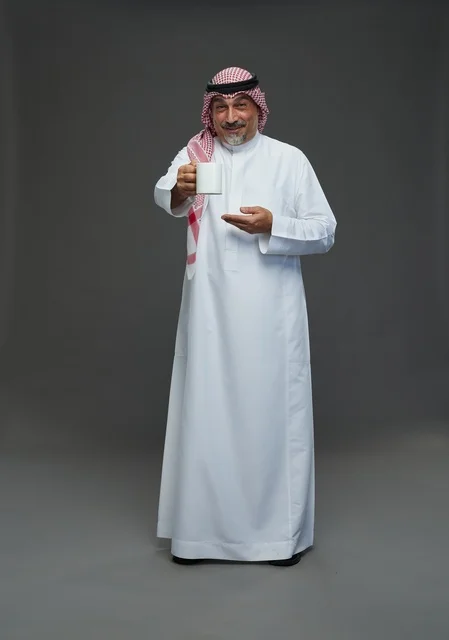 Elderly Saudi Man Holding White Mug in Studio