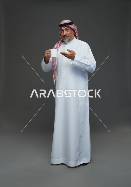 Elderly Saudi Man Holding White Coffee Mug in Studio
