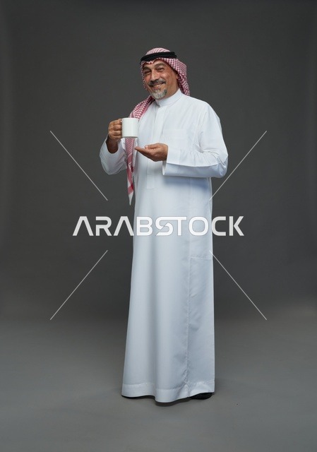 Elderly Saudi Man Holding White Mug in Studio