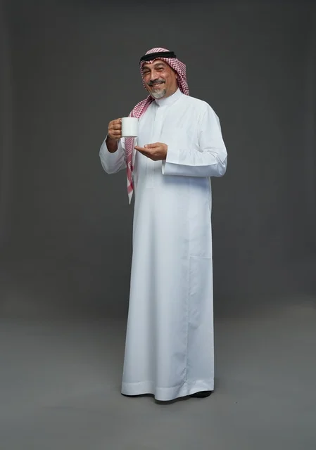 Elderly Saudi Man Holding White Mug in Studio
