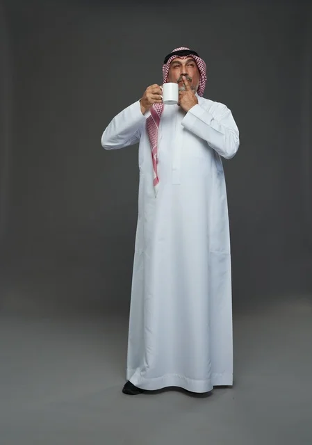 Elderly Saudi Man Holding White Mug in Studio