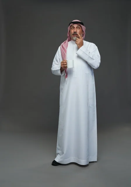 Elderly Saudi Man Holding White Mug in Studio