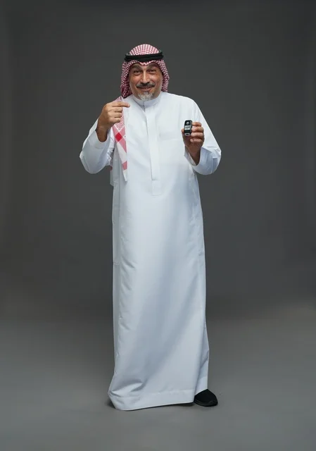Saudi Man Holding Car Key Fob Studio Portrait