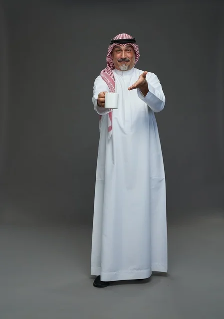 Saudi Senior Man Holding White Coffee Mug Studio Portrait