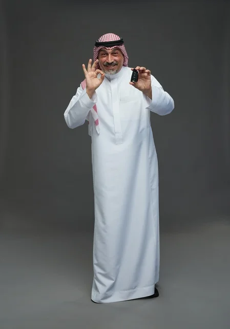 Saudi Man with Car Key and OK Gesture Studio Portrait