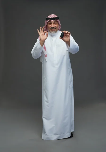 Saudi Man Holding Car Key with OK Gesture