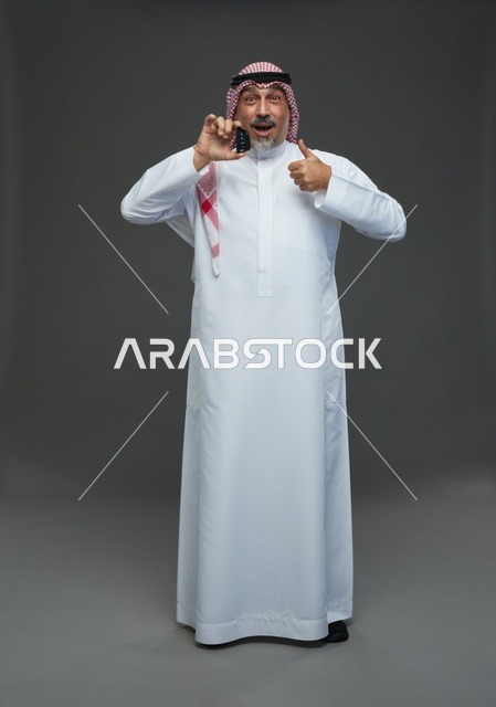 Saudi Man Holding Car Key With Thumbs Up Gesture