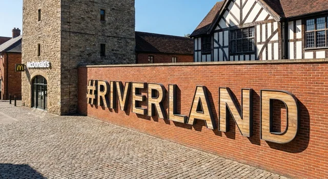 Riverland Dubai Parks and Resorts Signage on Brick Wall