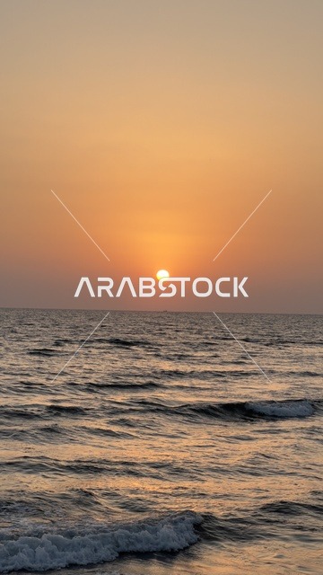 Sunset Over Sea Waves Under Orange Sky at Golden Hour
