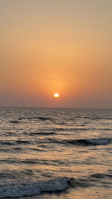 Sunset Over Sea Waves Under Orange Sky at Golden Hour