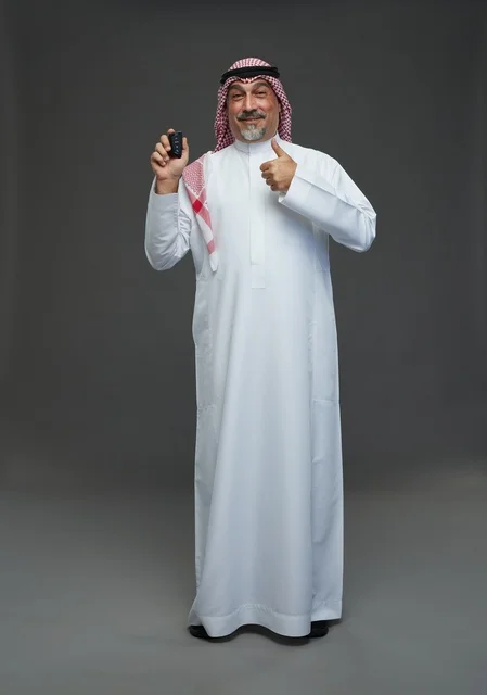 Saudi Man Holding Car Remote with Thumbs Up Gesture