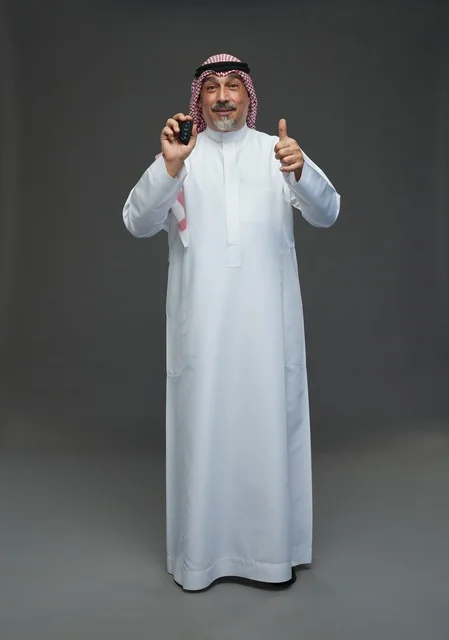Saudi Man Holding Car Key with Thumbs Up Gesture