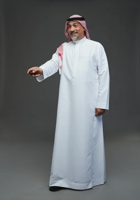 Senior Saudi Man with Remote Control in Studio