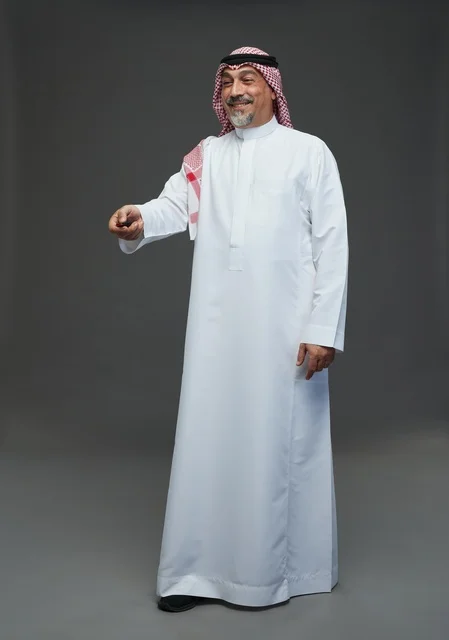 Saudi Man Holding Remote Control Against Grey Background
