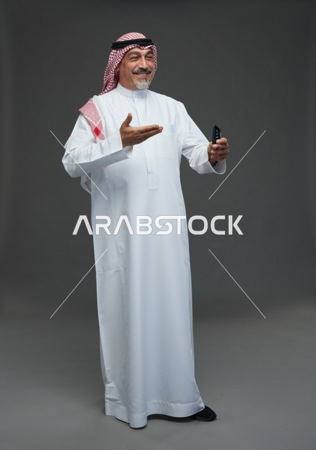 Saudi Man in Traditional Thobe Holding Car Remote Key