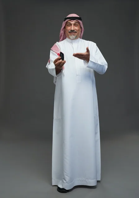 Saudi Man in Traditional Thobe Holding Car Key