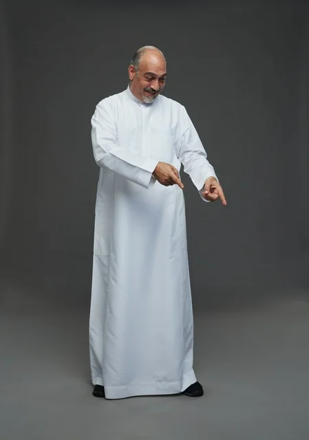 Saudi Man in White Thobe Pointing Down on Grey Background