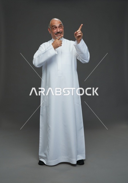 Mature Saudi Man in White Thobe Pointing Upward