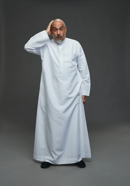Surprised Saudi Man in White Thobe on Grey Background