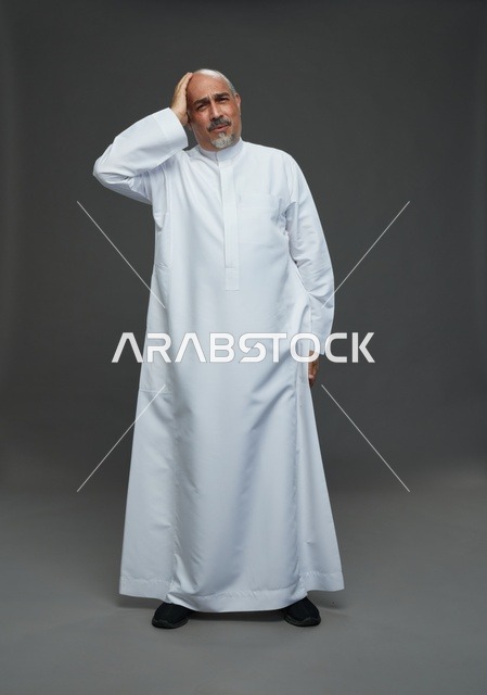 Stressed Saudi Man in White Thobe Studio Portrait