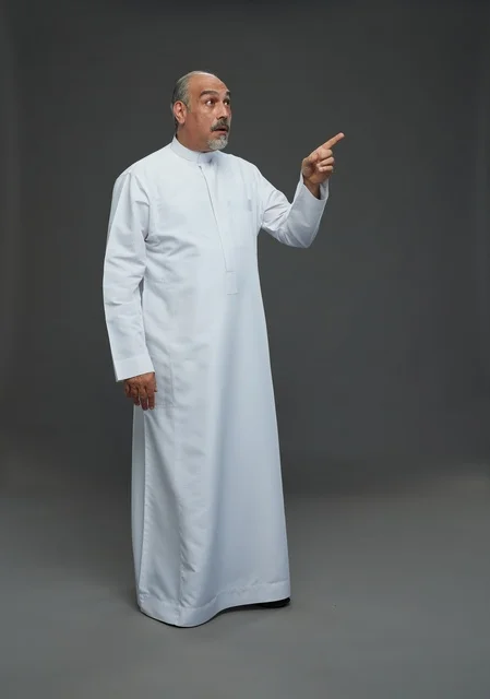 Surprised Arab Man in White Thobe Pointing Up