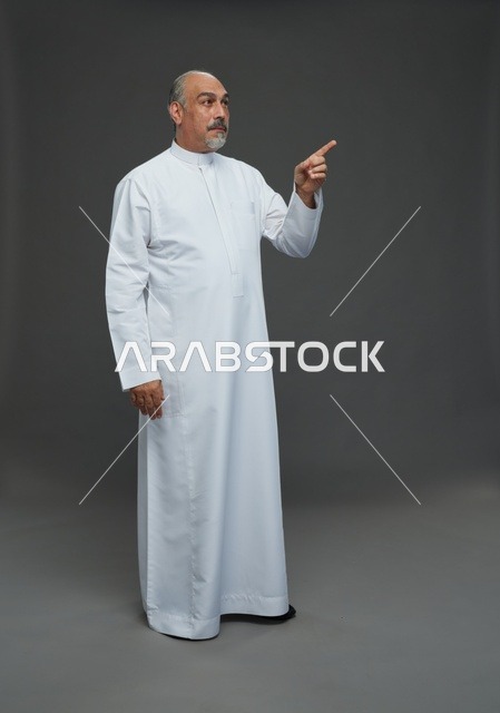 Arab Man in White Thobe Pointing on Gray Background