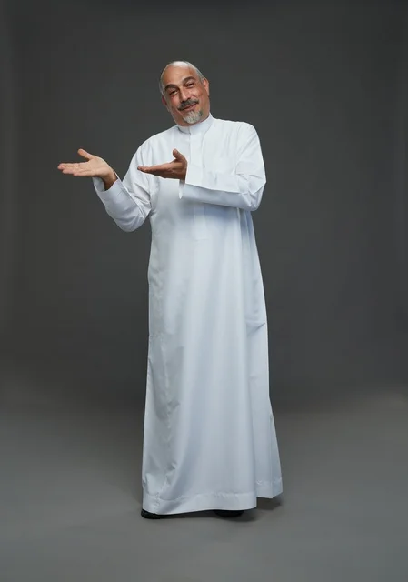Middle Aged Arab Man Presenting In White Studio Thobe