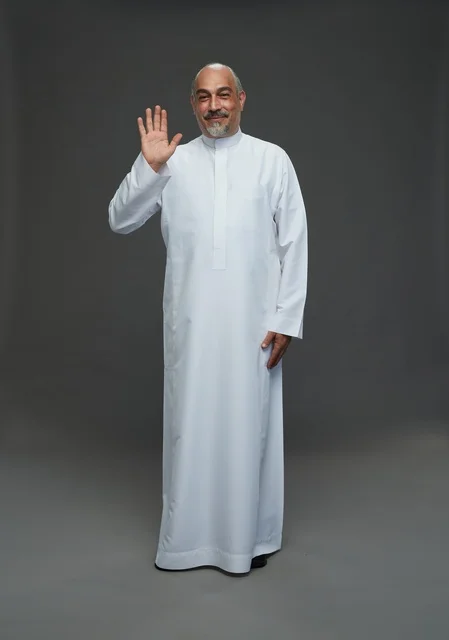 Senior Saudi Man in White Thobe Waving in Studio