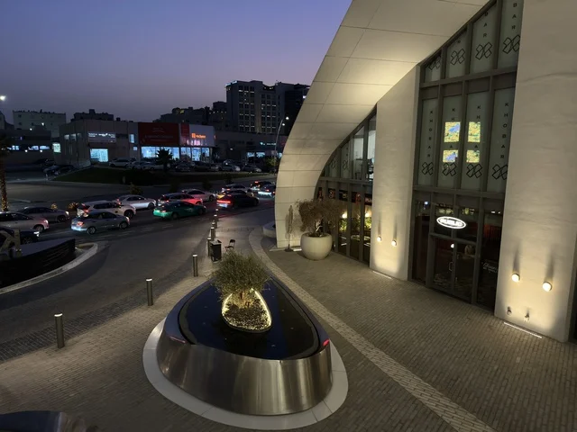 واجهة معمارية حديثة وشارع حضري مع إضاءة وقت الغسق