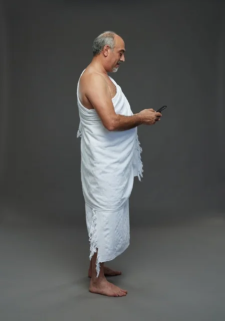 Arab Pilgrim in Ihram Using Smartphone Studio