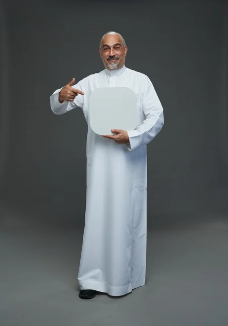 Saudi Man in Traditional Thobe Pointing at Blank Board